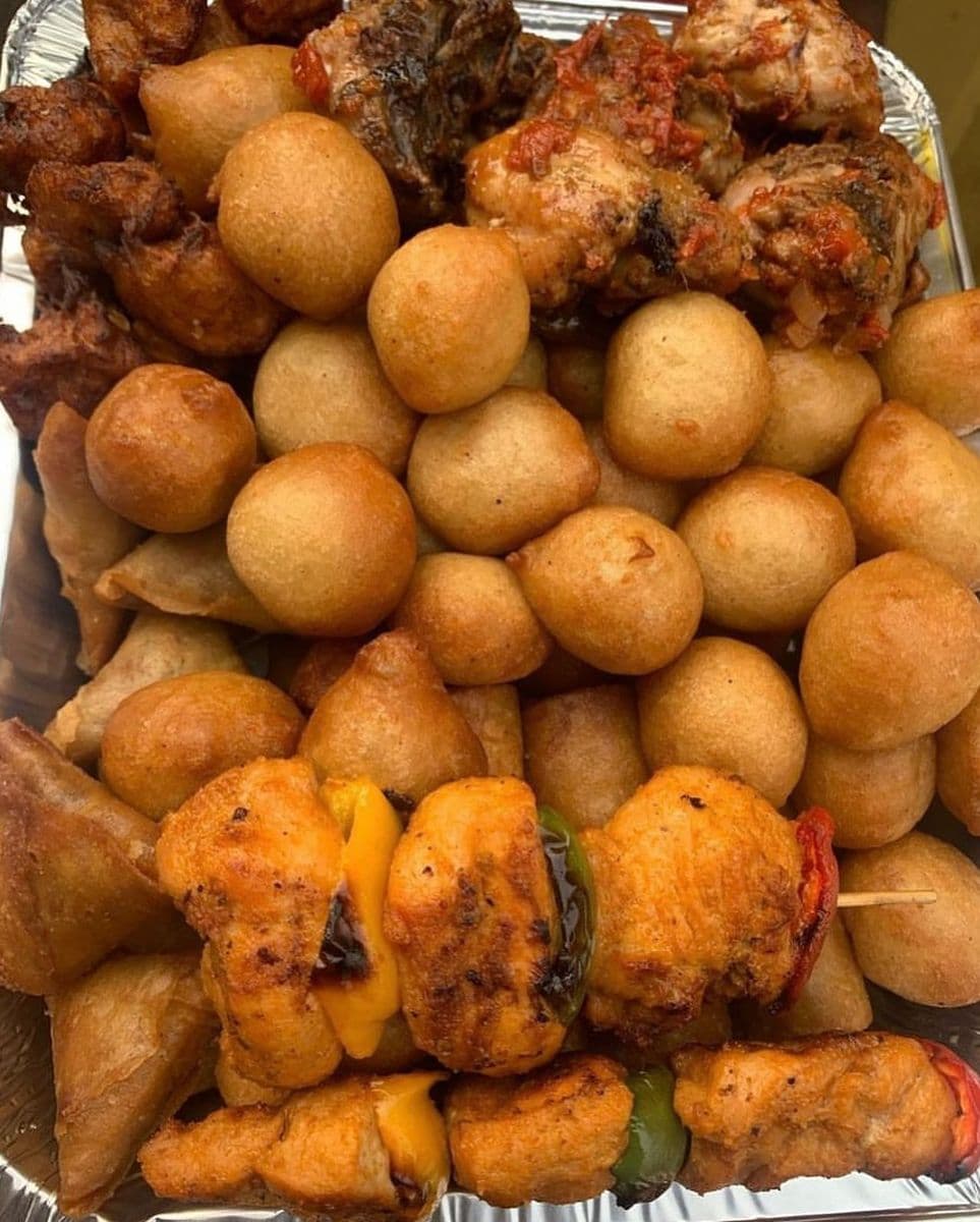 KAF Eatables tray of puff puff, spring rolls and peppered chicken skewers