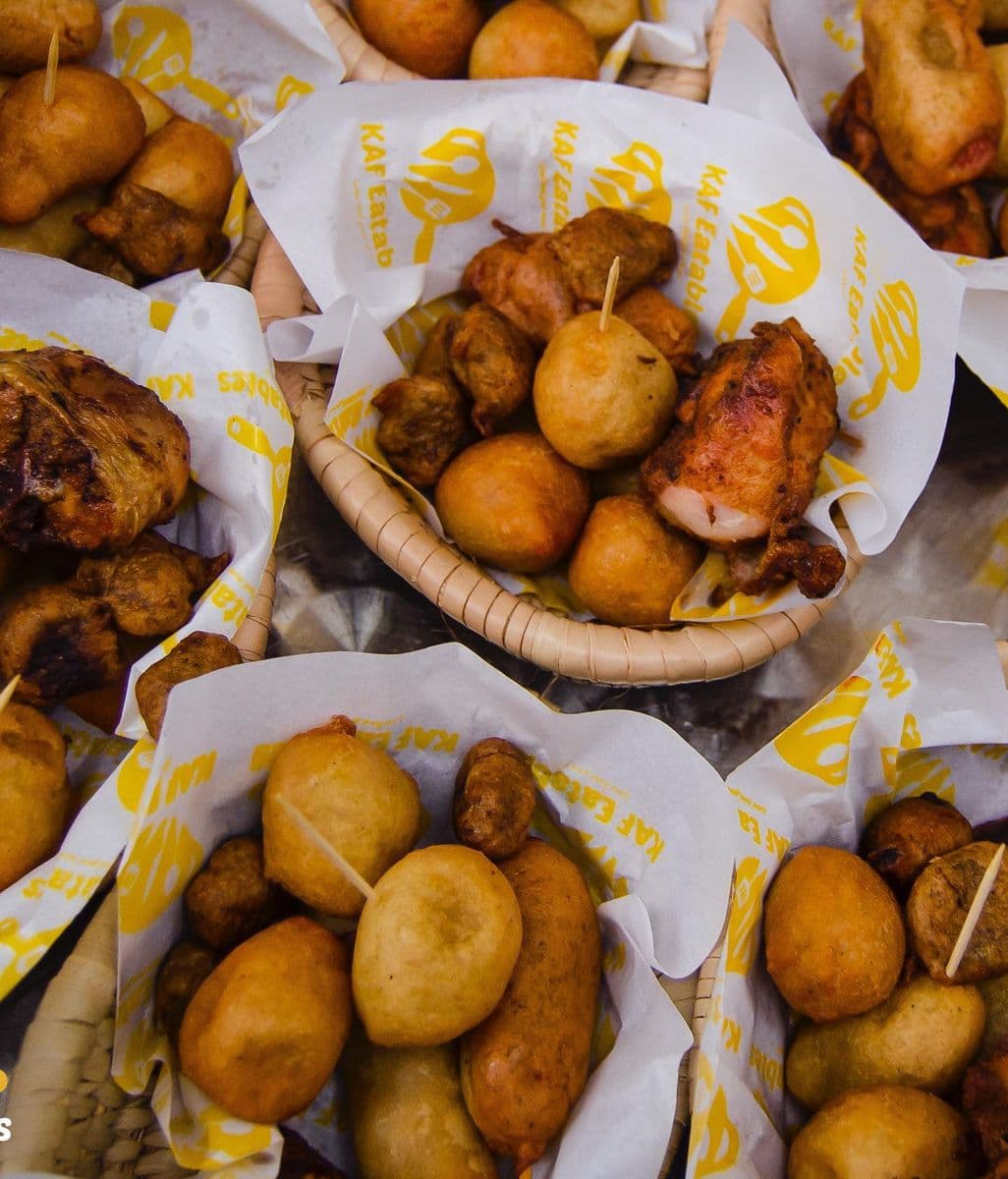 KAF Eatables branded baskets filled with puff puff and peppered chicken